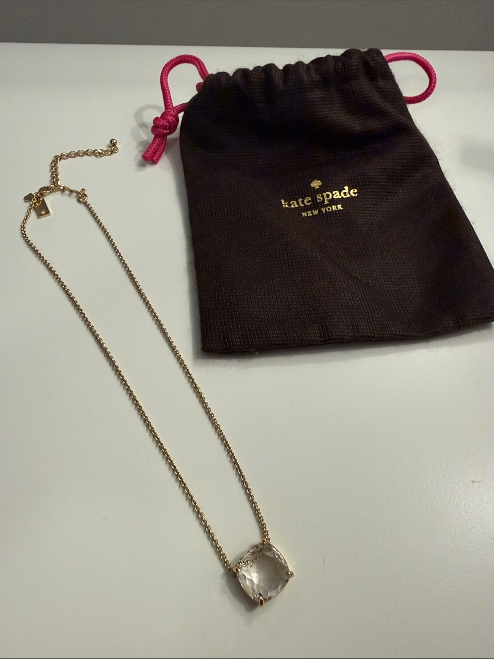 kate spade gold clear crystal pendant necklace with pink drawstring pouch